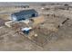 Expansive property featuring a blue house, detached garage, hot tub, and fenced yard at 253 E 8Th Ave, Byers, CO 80103