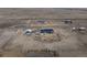 Aerial view showing a blue home and detached garage in an open rural area at 253 E 8Th Ave, Byers, CO 80103