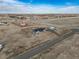 Aerial view of a blue home and detached garage on a sprawling property at 253 E 8Th Ave, Byers, CO 80103