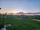 Backyard view showcasing a large grassy yard with play structure and fire pit at 253 E 8Th Ave, Byers, CO 80103