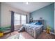 Nicely decorated bedroom with a storage bed and a blue accent wall at 253 E 8Th Ave, Byers, CO 80103