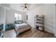 Inviting bedroom featuring hardwood floors, a ceiling fan, and natural light at 253 E 8Th Ave, Byers, CO 80103