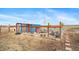 Fenced chicken coop with a shelter and several chickens on the property at 253 E 8Th Ave, Byers, CO 80103