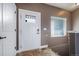 Entryway featuring a white front door, tile flooring, a window, and neutral wall colors at 253 E 8Th Ave, Byers, CO 80103