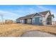 Rear exterior of the home showing a large yard, pergola covered patio, and a trampoline at 253 E 8Th Ave, Byers, CO 80103