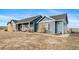 A single-story blue house features a charming facade and neatly landscaped yard at 253 E 8Th Ave, Byers, CO 80103