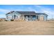 Charming single-story blue home with a well-maintained front yard and inviting curb appeal at 253 E 8Th Ave, Byers, CO 80103