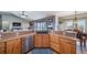Spacious kitchen with extensive countertops, stainless steel appliances, and wooden cabinetry, ideal for cooking and entertaining at 253 E 8Th Ave, Byers, CO 80103
