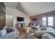 Spacious living room with high ceilings, a television, and neutral colored furniture at 253 E 8Th Ave, Byers, CO 80103