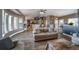 Open living room with a view of the kitchen and dining area, featuring wood floors at 253 E 8Th Ave, Byers, CO 80103