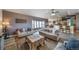 Spacious living room with hardwood floors, a ceiling fan, comfortable seating, and large windows for ample natural light at 253 E 8Th Ave, Byers, CO 80103