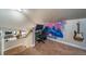 Cozy loft area featuring a gaming setup, a guitar, and eye-catching wall art at 253 E 8Th Ave, Byers, CO 80103