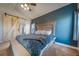 Spacious main bedroom with vaulted ceilings, a stylish barn door, and an en-suite bathroom at 253 E 8Th Ave, Byers, CO 80103