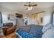 Comfortable main bedroom featuring a ceiling fan, TV on dresser, and a rustic barn door to the en-suite bathroom at 253 E 8Th Ave, Byers, CO 80103