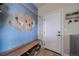 Functional mud room with a bench, coat rack, and convenient access to laundry area at 253 E 8Th Ave, Byers, CO 80103