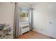 Cozy bedroom featuring light wood flooring, a window, and neutral-toned walls, creating a bright and inviting atmosphere at 1454 Jersey St # 2, Denver, CO 80220