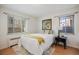Bright bedroom featuring hardwood floors, decorative art, and natural light from two windows at 1454 Jersey St # 2, Denver, CO 80220