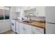 Clean kitchen featuring white cabinets, tile backsplash, modern sink and faucet, and gas range at 1454 Jersey St # 2, Denver, CO 80220