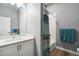 Well-lit bathroom with a white vanity, shower/tub combination, and modern fixtures with accessible features at 12278 Stone Timber Ct, Parker, CO 80134