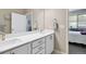Clean bathroom with double sinks, quartz countertop, and linen cabinet at 12278 Stone Timber Ct, Parker, CO 80134