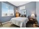 Bright bedroom with a plush bed, soft pillows, light blue walls, and a window with beautiful natural light at 12278 Stone Timber Ct, Parker, CO 80134