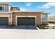 Attached garage with stone accents and ample parking space for residents and guests at 12278 Stone Timber Ct, Parker, CO 80134