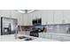 Bright kitchen with white cabinets, stainless steel appliances, and stylish countertops at 12278 Stone Timber Ct, Parker, CO 80134