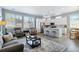Open-concept living space featuring a modern kitchen with white cabinets, a cozy living area, and abundant natural light at 12278 Stone Timber Ct, Parker, CO 80134