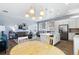 Open living space with modern lighting, a kitchen island, and a comfortable living room setup at 12278 Stone Timber Ct, Parker, CO 80134