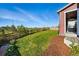 Landscaped backyard offering ample green space, complemented by a wooden fence and distant views at 4825 Basalt Ridge Cir, Castle Rock, CO 80108
