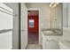 Bathroom featuring granite countertop and view through the doorway to an adjacent bedroom at 4825 Basalt Ridge Cir, Castle Rock, CO 80108