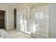 Bright bathroom features a spacious glass shower, white tile, and a convenient built-in seat at 4825 Basalt Ridge Cir, Castle Rock, CO 80108