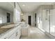 Spacious bathroom with double vanity, soaking tub, walk-in shower, and neutral tile flooring at 4825 Basalt Ridge Cir, Castle Rock, CO 80108