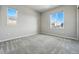 This bright bedroom offers comfortable carpeting and an abundance of natural light through its two windows at 4825 Basalt Ridge Cir, Castle Rock, CO 80108