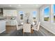 Bright dining area with modern table and chairs, large windows, and view of the landscape at 4825 Basalt Ridge Cir, Castle Rock, CO 80108
