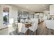 Bright dining area featuring a glass table, six chairs, and an open view to the kitchen and living room at 4825 Basalt Ridge Cir, Castle Rock, CO 80108