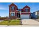 Well-maintained two-story home with stone accents, a front lawn, and an attached two-car garage at 4825 Basalt Ridge Cir, Castle Rock, CO 80108