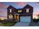 Elegant two-story home with stone accents, a well-manicured lawn, and an inviting entrance at 4825 Basalt Ridge Cir, Castle Rock, CO 80108