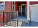 Charming front porch with stone accents, leading to a dark front door and attached garage at 4825 Basalt Ridge Cir, Castle Rock, CO 80108
