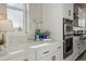 Modern kitchen featuring a white countertop, stylish backsplash, and stainless steel appliances at 4825 Basalt Ridge Cir, Castle Rock, CO 80108