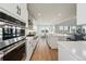 Spacious kitchen featuring stainless steel appliances, a large island, and an open layout leading to the living area at 4825 Basalt Ridge Cir, Castle Rock, CO 80108