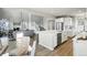 Open-concept living space with hardwood floors, a cozy fireplace, and seamless flow to the kitchen and staircase at 4825 Basalt Ridge Cir, Castle Rock, CO 80108