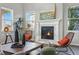 Cozy living room featuring a fireplace, modern decor, large windows for natural light, and stylish furniture at 4825 Basalt Ridge Cir, Castle Rock, CO 80108