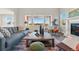 Bright living room with a comfortable couch, large windows, and a view of the backyard at 4825 Basalt Ridge Cir, Castle Rock, CO 80108