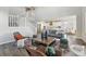 Open concept living space featuring a staircase, modern decor, and a view of the kitchen at 4825 Basalt Ridge Cir, Castle Rock, CO 80108