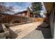 Private backyard featuring a patio, deck area, planter boxes, and a tall wooden fence at 9390 W Alabama Dr, Lakewood, CO 80232