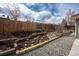 Landscaped backyard featuring a terraced rock garden and privacy fence for outdoor enjoyment at 9390 W Alabama Dr, Lakewood, CO 80232