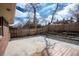 Private backyard featuring a concrete patio, deck, and well-maintained fence for added seclusion at 9390 W Alabama Dr, Lakewood, CO 80232