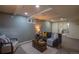 Finished basement featuring gray brick accent wall, neutral carpet, and dark blue sofas at 9390 W Alabama Dr, Lakewood, CO 80232