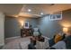 Finished basement featuring gray brick accent wall, neutral carpet and dark blue sofas at 9390 W Alabama Dr, Lakewood, CO 80232